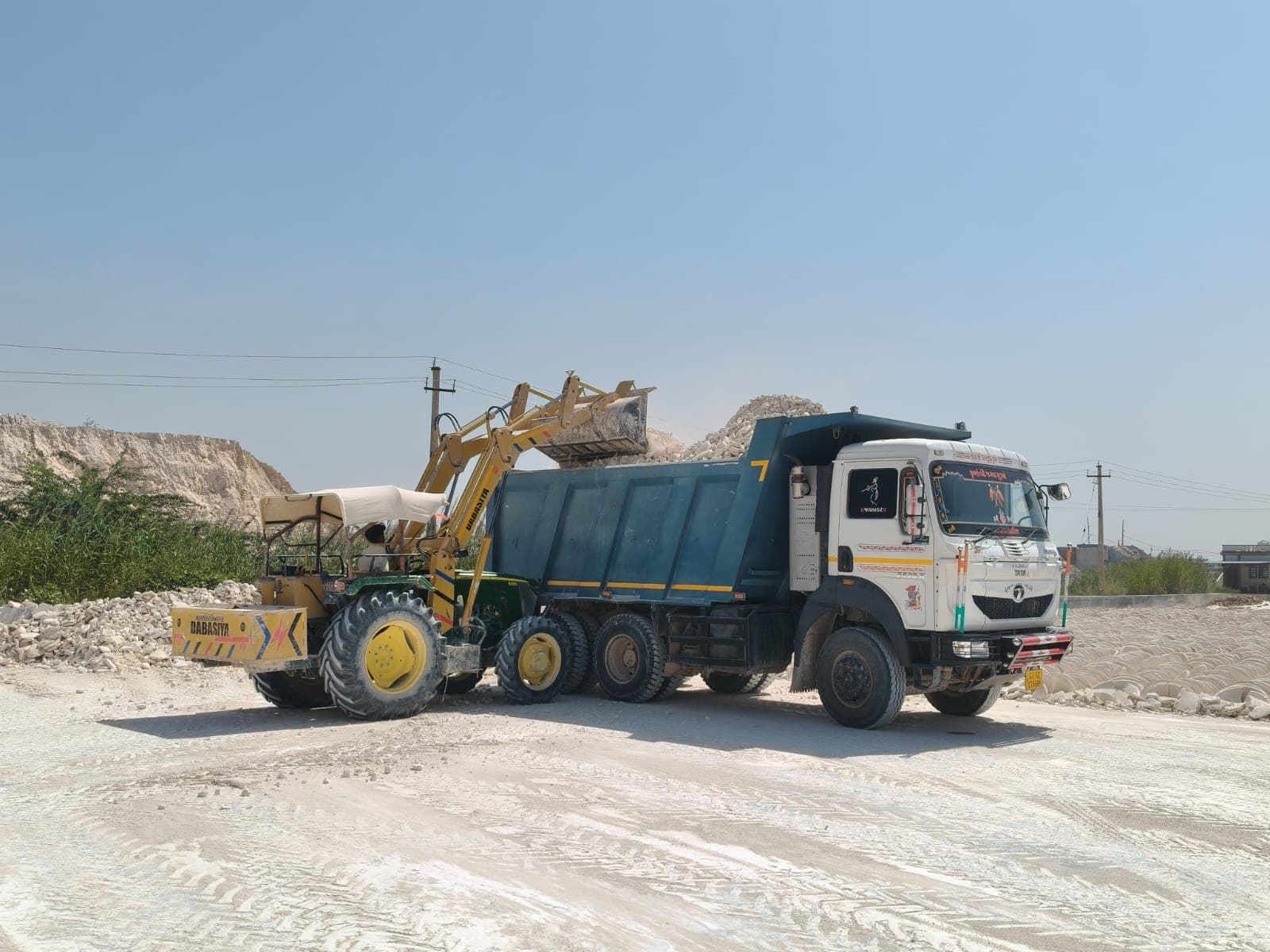 Loader filling a tipper truck with crude china clay lumps